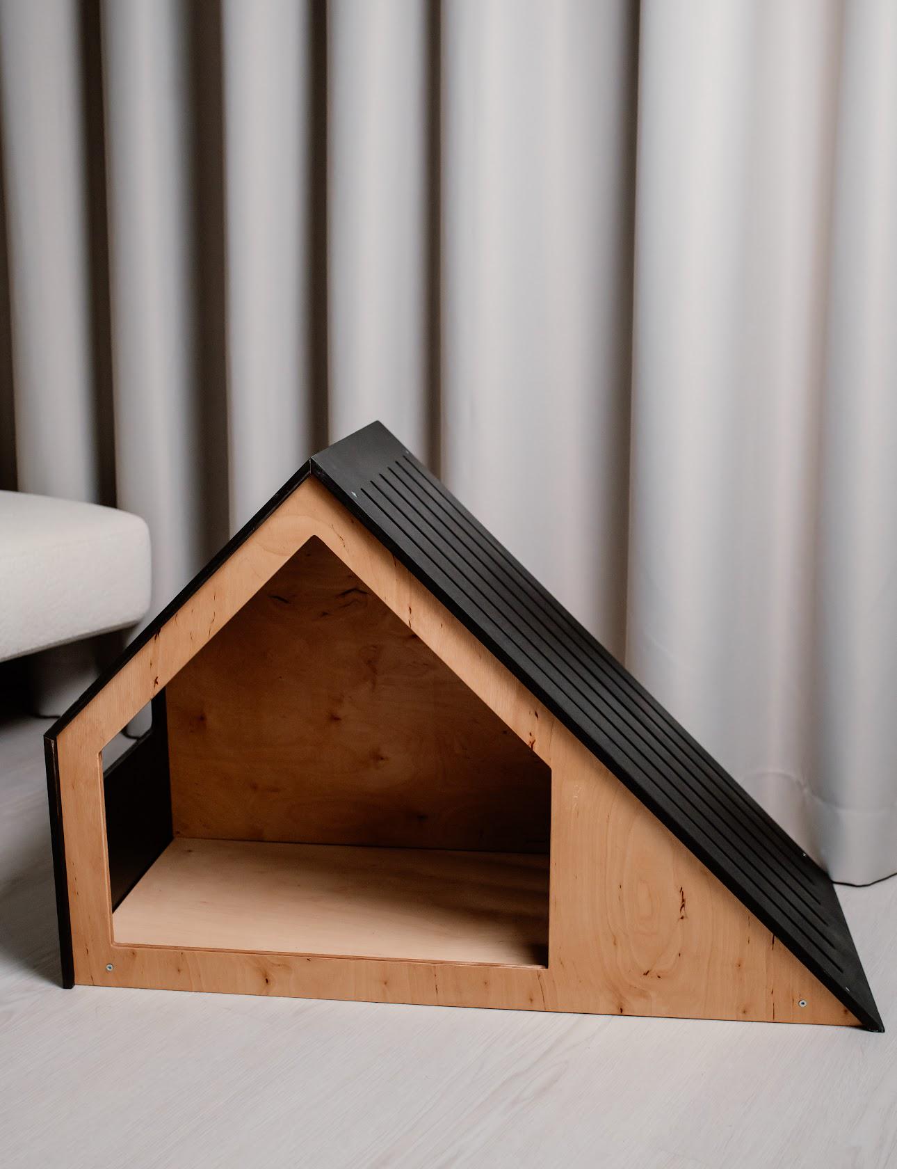 Dark wooden indoor dog house crate with modern barn-style design