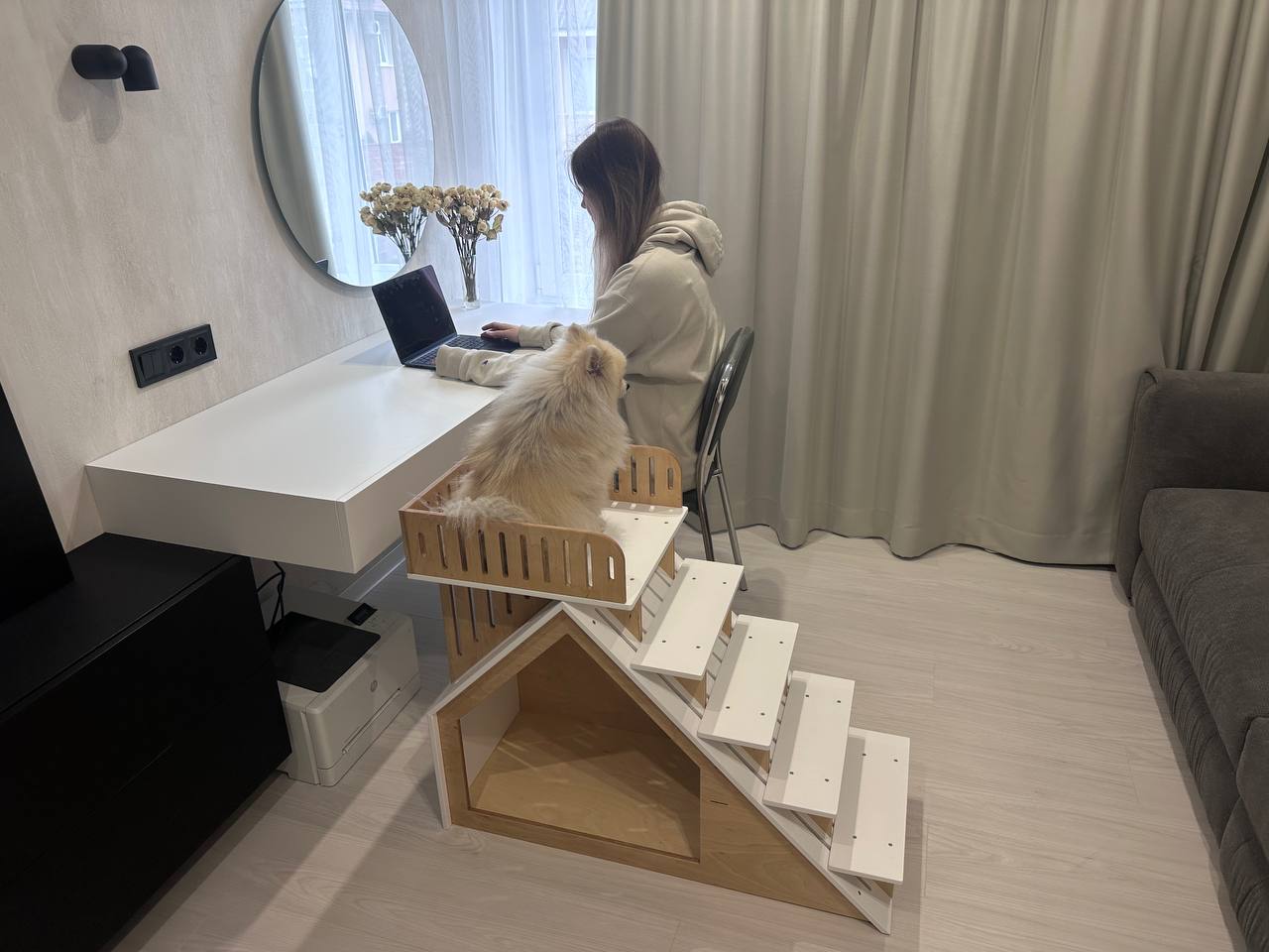 White wooden indoor dog furniture with stairs and feeding bowls