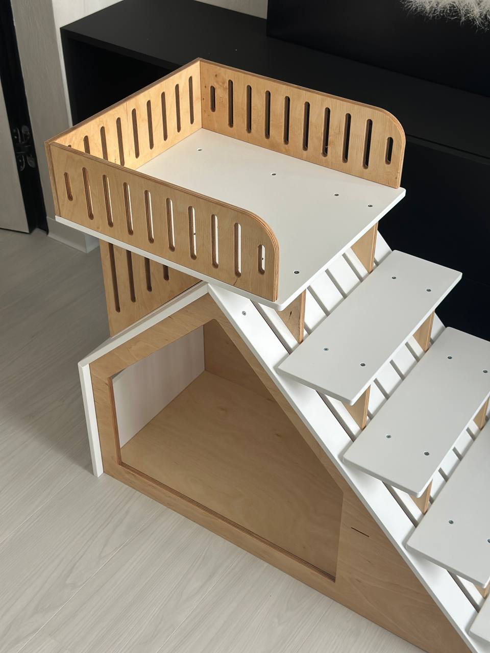 White small dog house with elevated platform wooden indoor