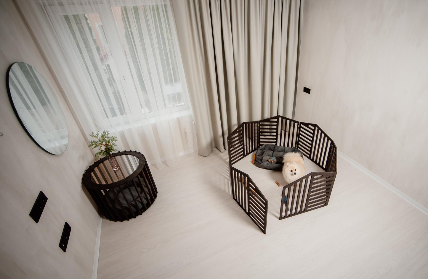 dark wooden dog playpen set up in a modern room with a small dog inside