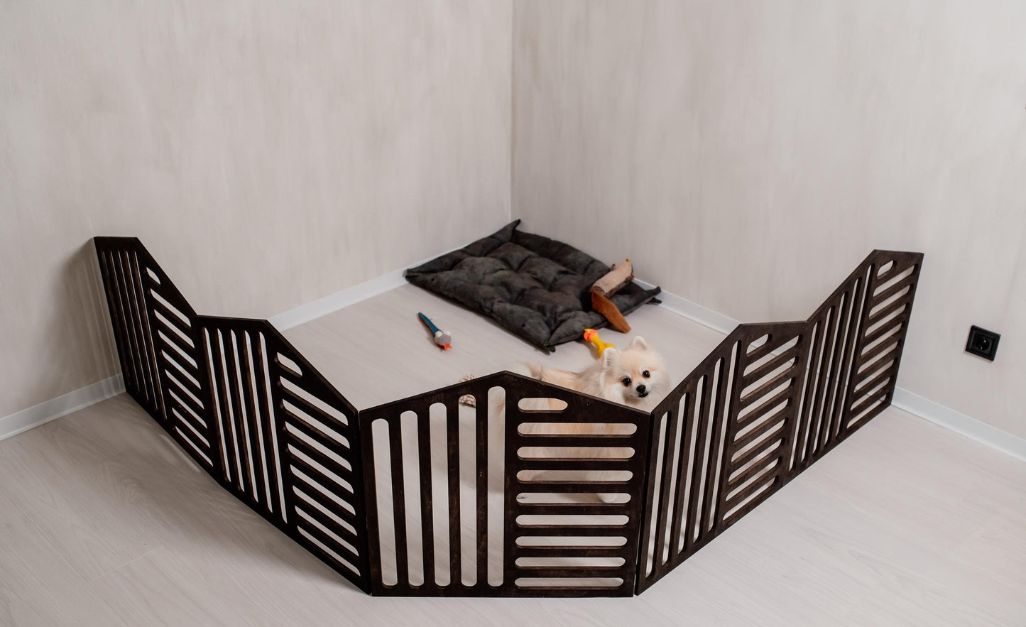 dark wooden dog playpen indoor setup with small dog