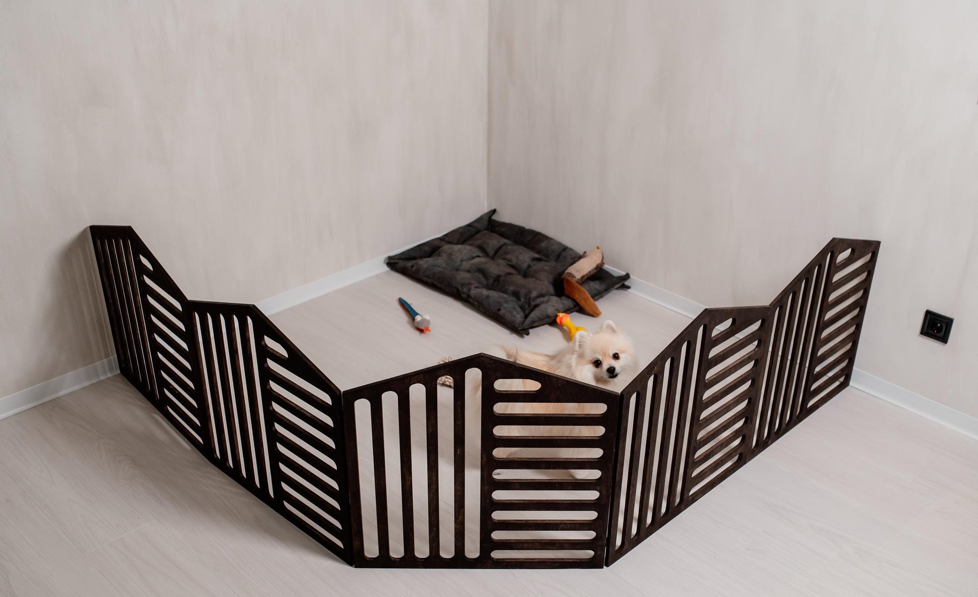 dark wooden dog playpen indoor setup with small dog