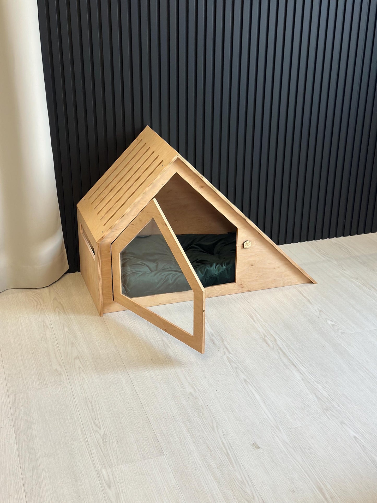 Indoor wooden dog house with open door, safe enclosed pet bed for small dogs or cats.