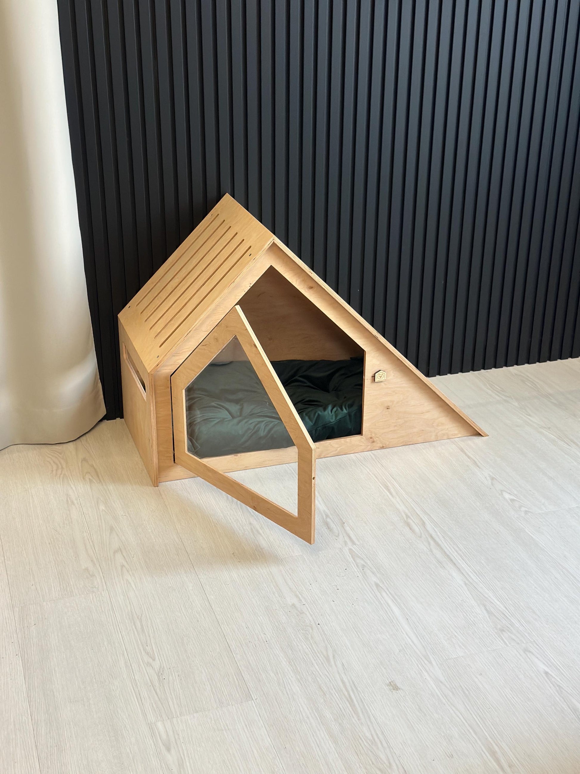 Indoor wooden dog house with open door, safe enclosed pet bed for small dogs or cats.