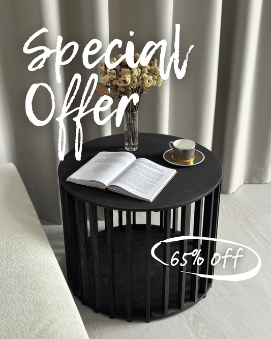 Modern black wooden dog house coffee table with a book, cup, and vase on top. Stylish Scandinavian pet furniture — limited edition, 65% off.