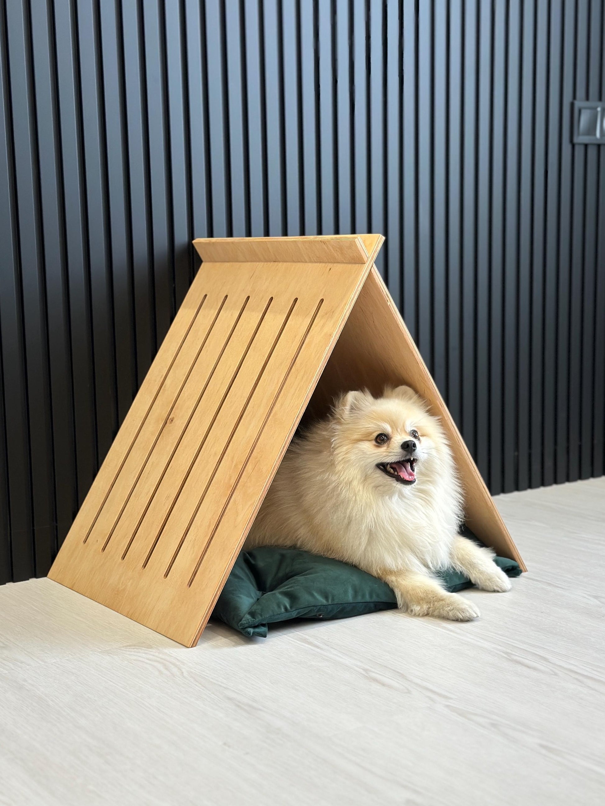 Small dog resting inside eco friendly wooden indoor dog crate house