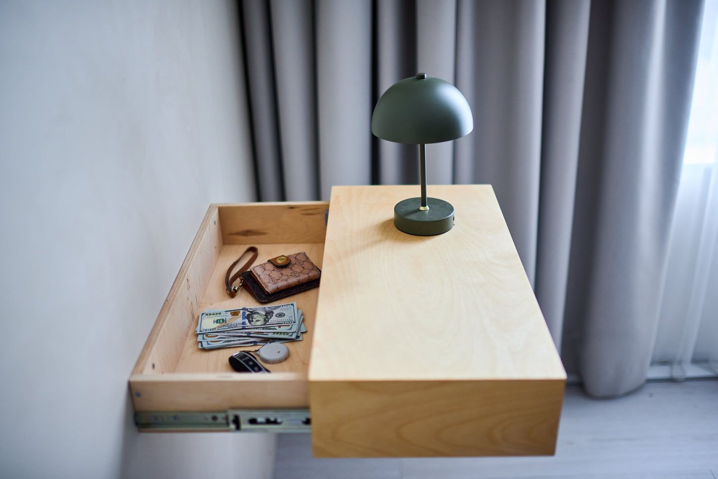 Close-up of the sliding hidden shelf mechanism revealing the concealed storage area.