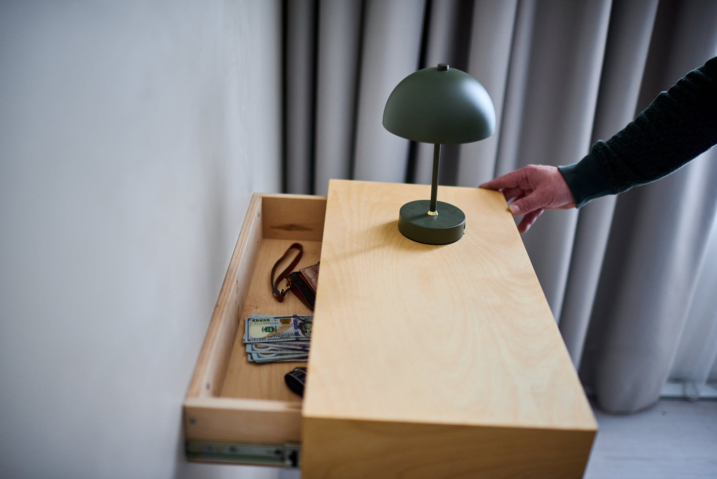 Hidden floating shelf opened to reveal a spacious secret compartment for cash, passports and valuables.