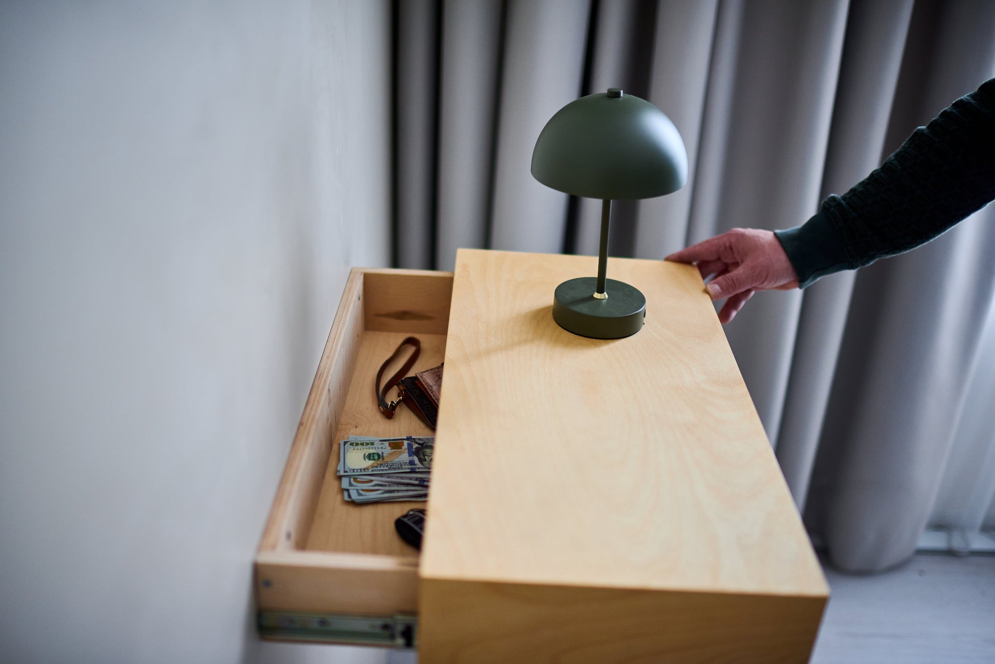 Hidden floating shelf opened to reveal a spacious secret compartment for cash, passports and valuables.