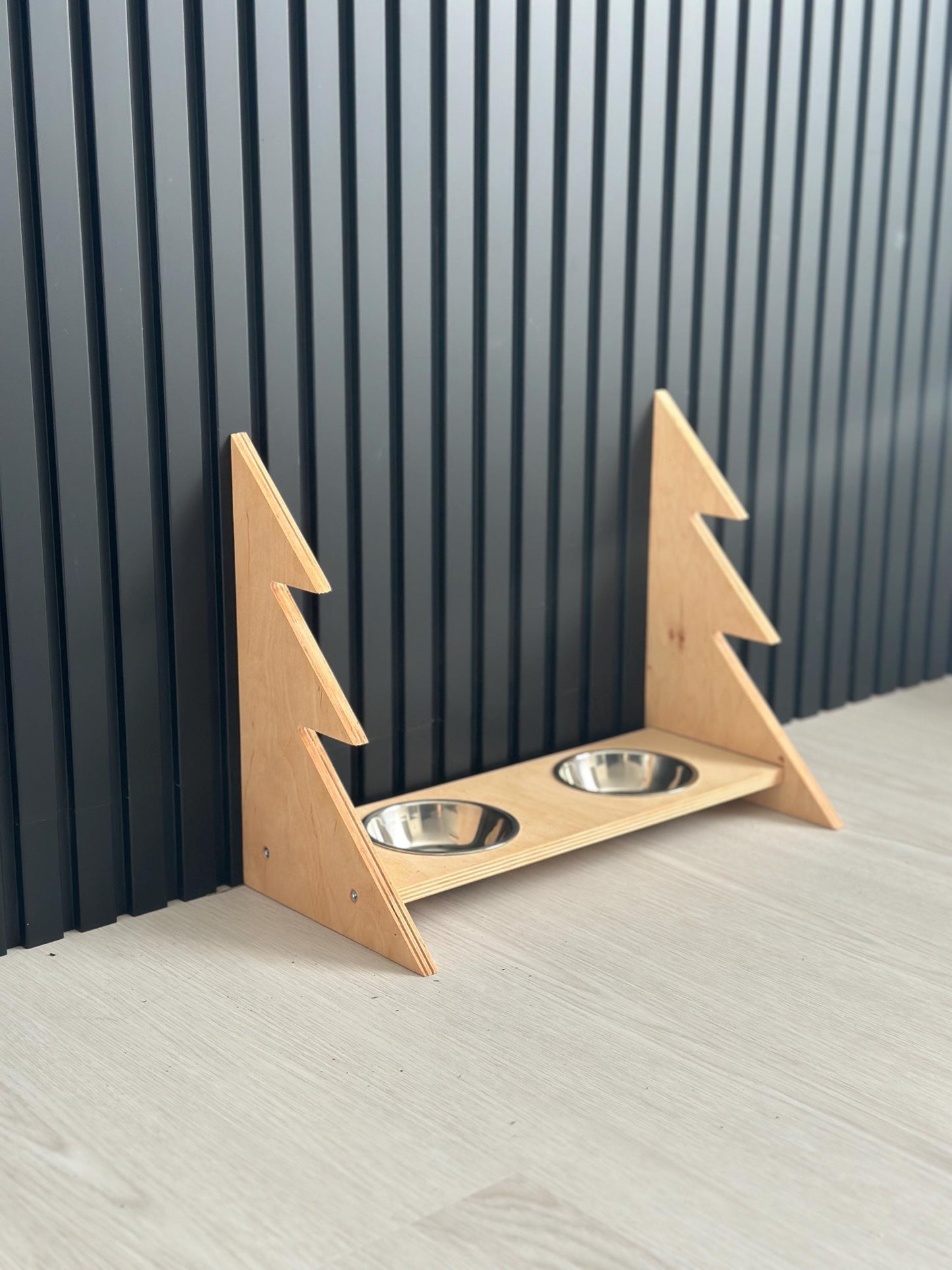 Light wood elevated dog feeder with holiday theme