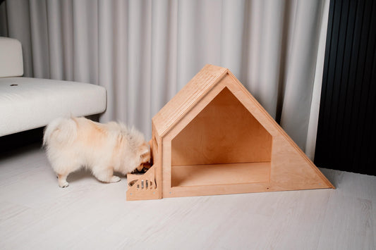 light wood dog house with sloped roof and feeder for small dogs