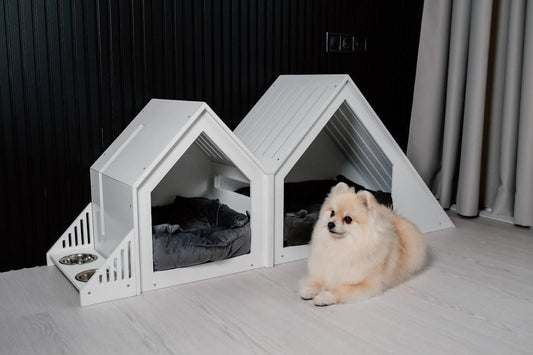 Small and large modern white wooden dog houses with pet bed inside