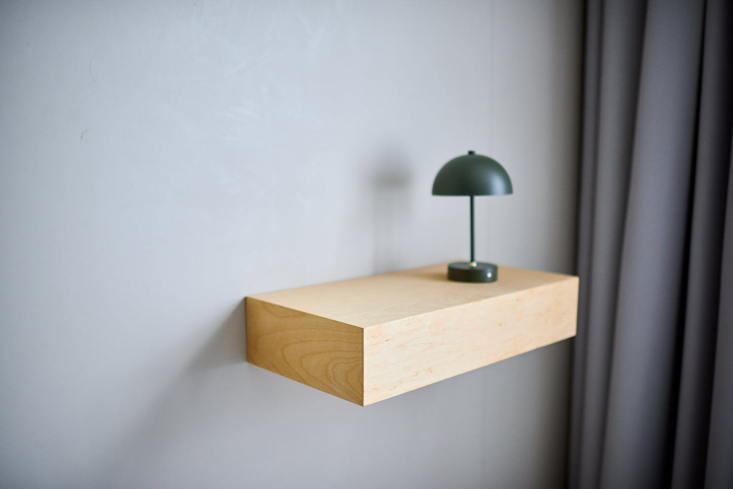 Modern wooden floating shelf that discreetly hides a secure storage compartment.