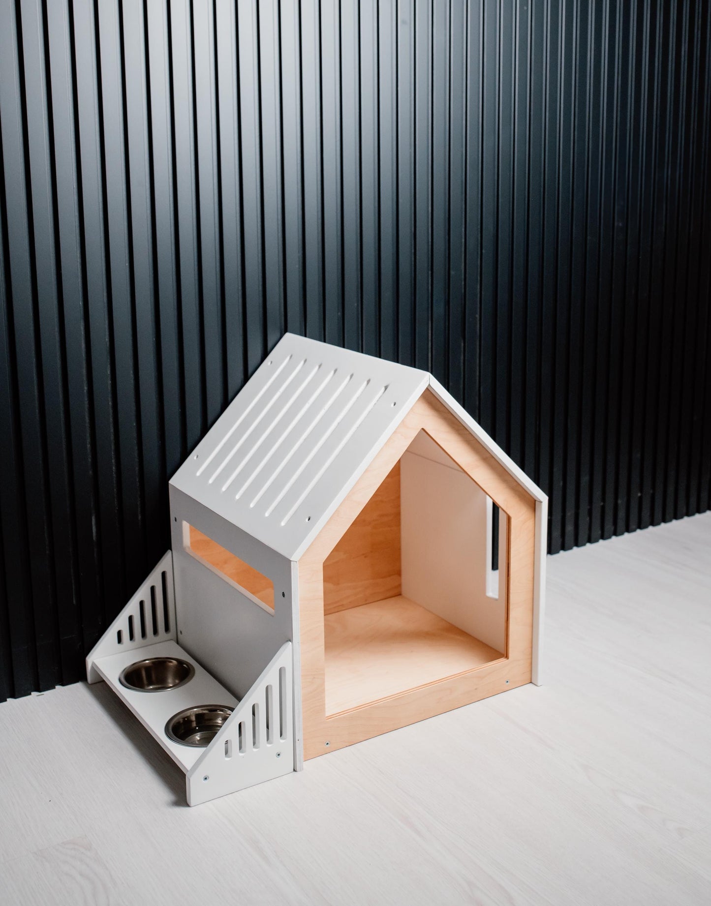 Modern small dog house with built-in wooden feeder in white finish, indoor puppy furniture for apartments