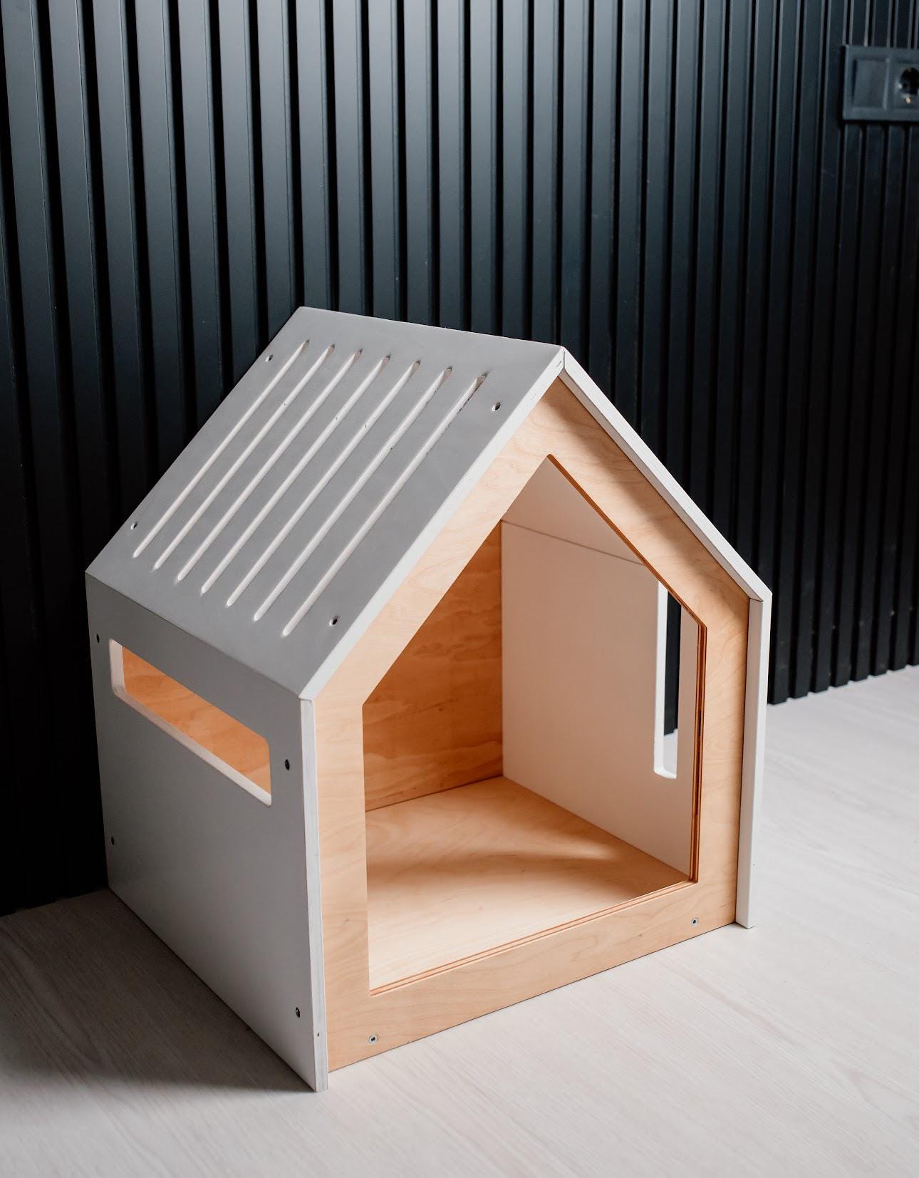 Modern wooden indoor pet house with white roof and open front