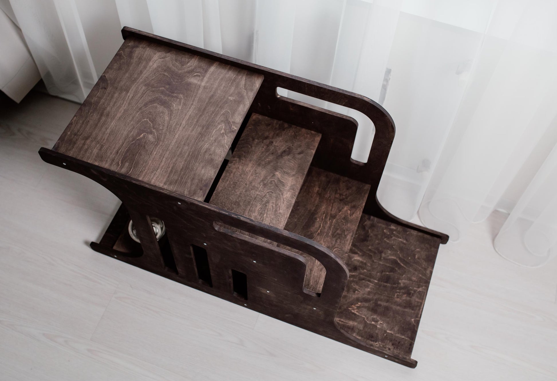 Side view of wooden dog house with stairs, modern indoor dog crate furniture for bedroom or living room.